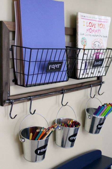 Organized art station for kid's art and craft supplies: Use hanging metal buckets for easy pencil, crayon and marker storage Art Station For Kids, Kids Art Space, Metal Buckets, Art And Craft Supplies, Homework Station, Marker Storage, Kids Art Supplies, Playroom Organization, Craft Area