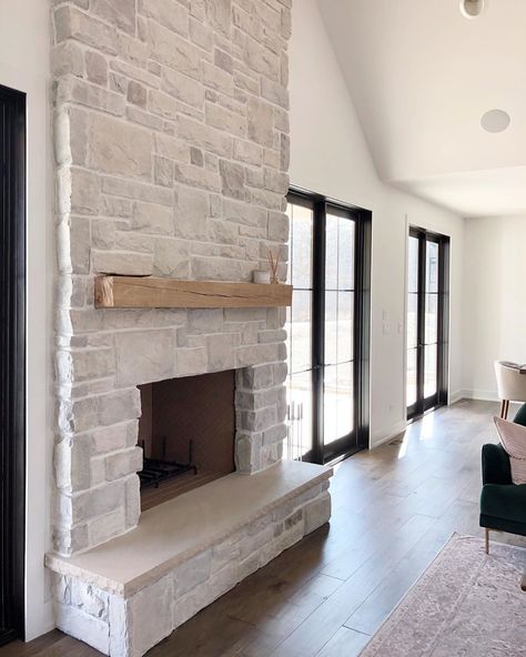 Fireplace stone and floating mantle White Stone Fireplace With Black Mantle, Stone Fireplace Inspiration, Modern Farmhouse Fireplace Stone, Coastal Stone Fireplace, Stone Electric Fireplace Ideas, Floating Hearth Fireplace, White Stone Fireplace With Wood Mantel, Half Stone Fireplace With Mantle, Stone Fireplace Wood Mantle