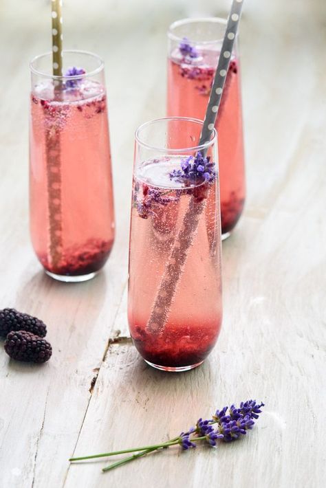 This champagne cocktail gets a unique twist with a simple blackberry and lavender sauce that is super easy but looks stunning! Perfect for entertaining with delicious real ingredients. Lavender Sauce, Pink Champagne Margarita, Peach Bellini Recipe, Lavender Champagne, Blackberry Lavender, Champagne Margaritas, Champagne Recipes Cocktails, Bellini Recipe, Spring Drink