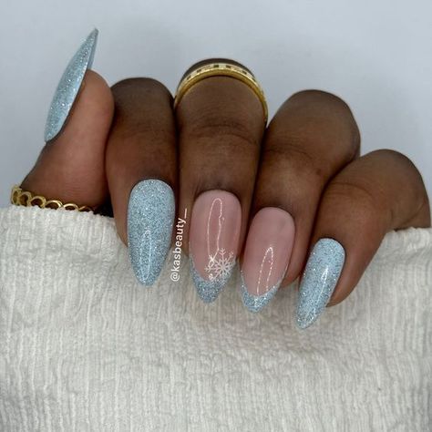 15 Winter Nail Ideas for Dark Skin Tones in 2023-2024 - thepinkgoose.com Blue Christmas Nails 2023, Light Blue Glitter French Tip Nails, Wintery Blue Nails, Blue Glitter Christmas Nails, Christmas Nails Acrylic Blue, Blue Medium Nails, Blue Snowflake Nails Acrylic, Light Blue Snowflake Nails, Light Blue Glitter Nails