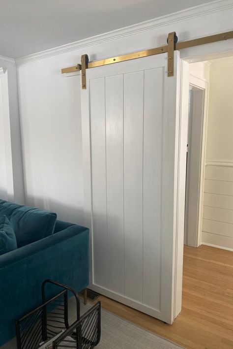 Barn Door Wainscoting, Medium Wood Floors, Shiplap Barn Door, Door In Living Room, Living Room With White Walls, Shiplap Door, Barn Door White, Room With White Walls, Original Farmhouse