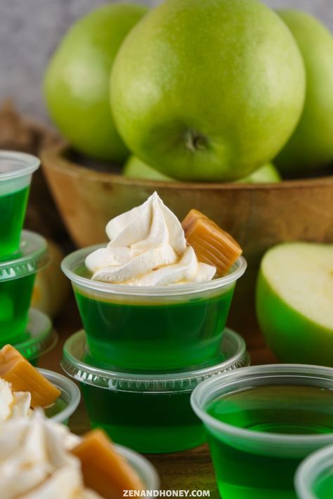 Caramel Apple Jello Shots - ZEN AND HONEY Fall Jello Shots, Caramel Apple Jello Shots, Apple Jello Shots, Caramel Apple Shots, Halloween Party Foods, Fun Halloween Snacks, Halloween Jello Shots, Easy Halloween Party Food, Jello Flavors