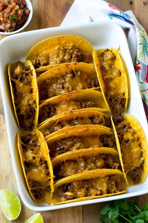 Baked beef tacos topped with melted cheese in a casserole dish. Bake Tacos, Tacos In The Oven, Baked Beef Tacos, Tacos For A Crowd, Turkey Tacos Recipes, Oven Baked Tacos, Oven Tacos, Baked Tacos, Ground Turkey Tacos