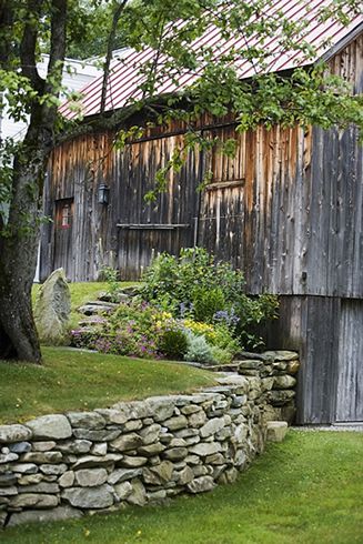 Old Country Barn + Great stacked stone retaining wall..except for the snakes. Stone Wall For Garden, Barnstone Retaining Wall, Stone Garden Fence, Stone Wall In Front Of House, Backyard Patio Retaining Wall, Old Stone Wall Garden, Rock Walls Landscaping, Fieldstone Retaining Wall, Stone Terrace Garden