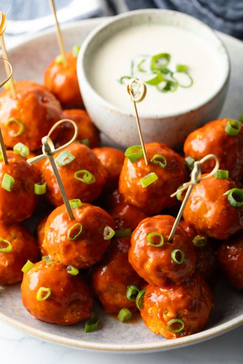 Plate of buffalo chicken meatballs skewered with serving toothpicks, nestled next to a white dish of ranch dressing dipping sauce. Buffalo Meatballs, Meatball Skewers, Ranch Dressing Dip, Chicken Meatballs Recipe, Chicken Skewer Recipe, Buffalo Chicken Meatballs, Chicken Wing Sauces, Chicken Meatball Recipes, Spicy Wings