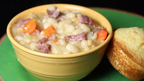 This recipe for a hearty ham white bean soup calls for carrots, celery, onion, bay leaves and mustard powder. Navy Bean Soup, Ham And Bean, Gravy Packet, Daniel Plan, Country Gravy, Bean Soup Recipe, Ham Bone, Ham Soup, Ham And Beans