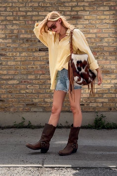 Summer outfit idea: frye harness boots, denim cut off shorts, vintage oversized button down and an oversized fringe bag. I love this easy outfit idea, it felt fun and coastal with a little bit western. The oversized sunnies are vintage from the 70's. This big shorts small pants outfit is the perfect summer festival outfit idea. • coastal cowgirl • festival outfit ideas • summer outfit ideas • frye harness boot outfit • cowhide purse • butter yellow shirt • butter yellow • pale yellow • Cowgirl Festival Outfit, Cowgirl Festival, Festival Outfit Ideas, Big Shorts, Frye Harness Boots, Cowhide Purse, Summer Festival Outfit, Easy Outfit, Yellow Shirt