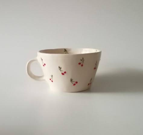 Introducing our exquisite handmade ceramic cup, a testament to craftsmanship and attention to detail. Each cup is meticulously shaped and adorned with a charming, hand-painted tiny cherry motif, adding a touch of whimsy to your daily rituals. Elevate your sipping experience with this unique piece that seamlessly combines functionality with artistic flair. Crafted with care, this cup is a delightful addition to any collection, promising both aesthetic pleasure and practical use. HandmadeCup, CeramicArt, CherryDesign, ArtisanPottery, WhimsicalCup, HandcraftedDrinkware, UniqueCeramics,CherryMotif, FunctionalArt, HomeDecor Kitchenware, ArtisticCup, CollectibleCeramics Painting On Tea Cups, Cherry Mug Painting, Cute Kitchenware, Painting Cups, Hand Painted Coffee Mugs, Cute Bowls, Paint Cups, Ceramics Cup, Cup Painting