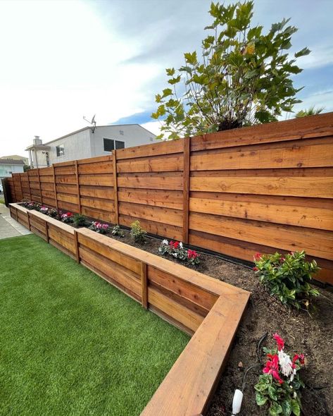 Built planter boxes along the fence line to create a beautiful and functional garden space. The planter boxes will not only add visual appeal to the fence line but also provide an opportunity to grow a variety of flowers. Planter boxes from @glscapes Backyard Raised Planter Ideas Along Fence, Backyard Garden Boxes Along Fence, Flower Box Along Fence, Long Flower Boxes Planters, Fence With Garden Boxes, Planter Boxes On House, Planter Along Fence Line, Planter Against Fence, Backyard Planter Boxes Along Fence