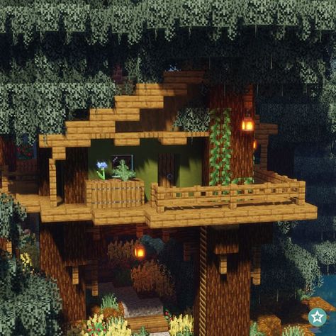 A one-story Treehouse in the game Minecraft supported by six individual trees. It is located in a dense Northern Forest. The frame is mainly made out of Spruce Wood. The walls have a dark green finish which matches perfectly with the leaves of the trees. There are two balcony's, one located in the front and the other located on the left side of the house. Beneath the treehouse there are some crop fields. Treehouse In Minecraft, Minecraft Cottage House, Minecraft Treehouses, Minecraft Tree, Minecraft Garden, Minecraft Aesthetic, Minecraft Structures, Bangunan Minecraft, Minecraft Farm