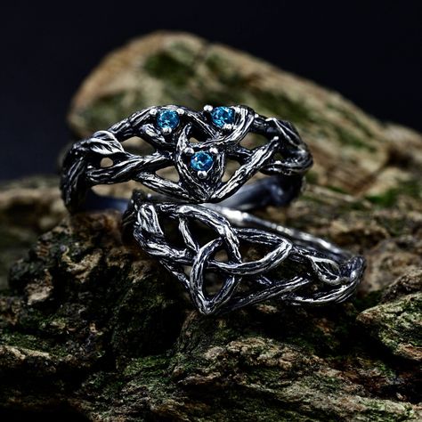 Crafted from sterling silver, our matching Viking wedding bands boast intricate designs inspired by celtic forests, perfect for couples seeking a unique symbol of their love. The wiccan love knot engagement ring adds a touch of mystique, while the aquamarine fantasy branch enhances its ethereal charm. This non-traditional set, featuring delicate branch and leaf motifs intertwined with celtic trinity knots. Characteristics: Metal - Recycled solid sterling silver  Stone - Cubic Zirconia Finish - Oxidized. View all silver celtic engagement rings: https://www.etsy.com/shop/TinyShinyJewel?ref=seller-platform-mcnav&section_id=44336419 Care instructions: To care for the ring, avoid contact with water and chemicals such as perfumes and lotions. When the ring is not in use, store it in a dry, cool Viking Wedding Ring Sets, Viking Engagement Ring, Celtic Forest, Fantasy Wedding Rings, Celtic Wedding Ring Sets, Knot Engagement Ring, Forest Ring, Viking Wedding Ring, Engagement Ring Sapphire