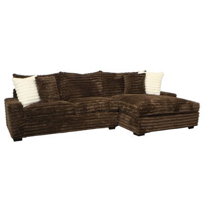 This sofa-and-chaise sectional is a bold, plush addition to your living room, able to accommodate four people for movie night or the big name. It has a solid and engineered wood frame that rests on low-profile black block feet. Wrapped in a thickly ribbed polyester fabric, it's filled with foam over sinuous springs for ample support as you relax. A muted color palette makes it easy to blend with your current aesthetic. And four toss pillows are included for another layer of comfort. Wade Logan® Brown Fabric Couch, Redecorate Living Room, New House Construction, Cuddler Sectional, Current Aesthetic, Brown Sectional, Sofa Slipcover, Muted Color Palette, Chaise Sectional