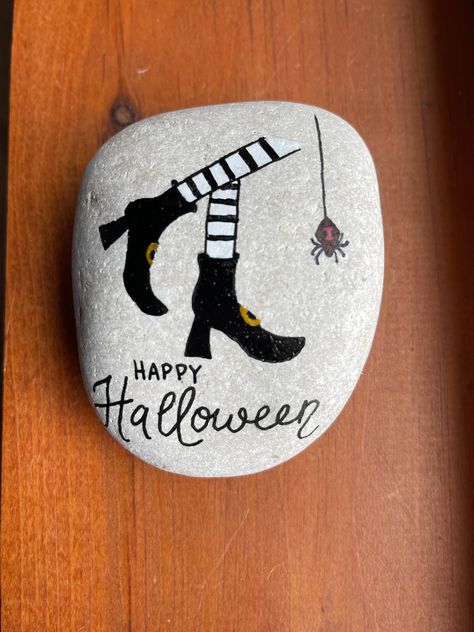 "Hand painted on a natural rock are witch's legs and a spider!  Sealed with gloss varnish to help preserve the art.   measures 4\" x 3 \" x 2\"." Halloween Stones, Fall Rocks, Halloween Witch Legs, Painted Seashells, Witch Painting, Fall Rock, Doodle Art Flowers, Happy Halloween Witches, Halloween Pumpkins Painted