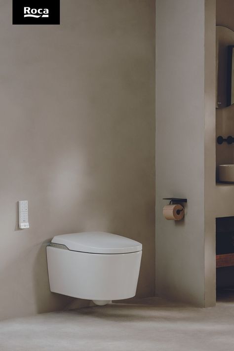 A grey wall with a white rectangular remote. Under the remote and to the right is a white toilet. On it is a horizontal line of silver buttons is on the underside of the toilet lid. Designer Toilet, Roca Bathroom, Smart Bathroom, Smart Toilet, Bathroom Inspo, Smart Solutions, Toilets, New Generation, Bathroom Design