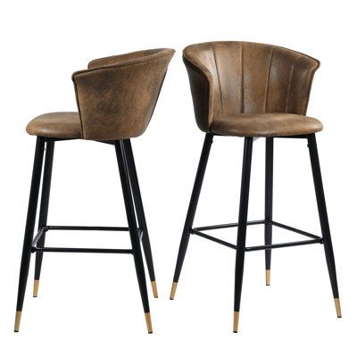 This 2-piece set of counter stools brings modern style to your home bar or kitchen island. Made from solid and engineered wood, it features a clean-lined silhouette with an armless design that makes it easy to tuck under your kitchen island or home bar. Its bucket silhouette has a curved, low back that's wrapped in foam and upholstered in faux leather with channel tufting and a solid hue that's easy to pair with your aesthetic. Plus, the four splayed and tapered legs prop up a footrest for your Chaise Haute Bar, Fabric Bar Stool, Bar In Casa, Bar Metal, 30 Bar Stools, Counter Bar, Bar Height Stools, Bar Stool Chairs, Leather Bar Stools