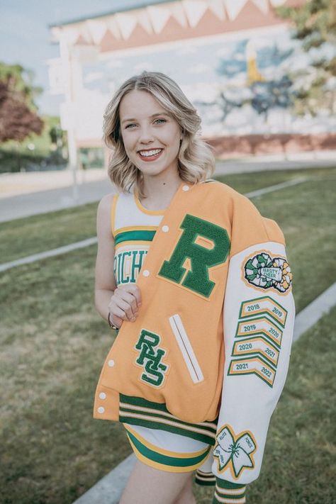 A cheerleader shows off her patches on her Varsity letterman jacket. She is on the richland high school campus. Varsity Jacket Cheerleader, Letterman Patches Ideas, Bedazzled Letterman Jacket, Lettermen Jacket Ideas, High School Letterman Jacket Ideas, Cheer Letterman Jacket Ideas, Varsity Jacket Senior, Cheer Letterman Jacket, Varsity Jacket Patches