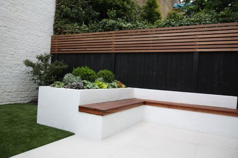 Paint it black; black will enhance your garden design Black Garden Walls, Black Fences In Garden, Black Retaining Wall Garden, Black Garden Wall, Black Fence Garden, Garden Wall Colours, Painted Retaining Wall, Black Retaining Wall, Gazebo Seating