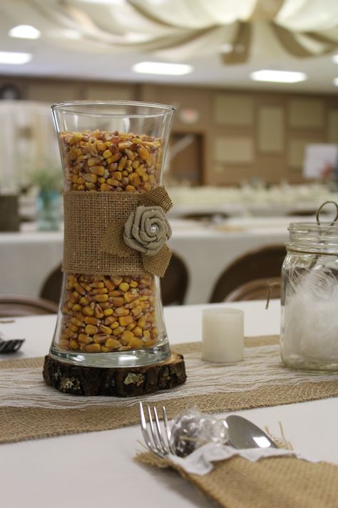 Farm theme wedding with burlap and lace decor.  This corn filled vase with burlap ribbon sat on a runner for centerpieces on the tables.  We also used jars of feathers.  We incorporated things from our family farms into our wedding decor. Farm Theme Graduation Party, Rice Centerpieces, Barn Theme Centerpieces, Farm Theme Wedding, Quick Easy Family Meals, Ffa Banquet, Farm Wedding Decorations, Farm Table Decor, Auction Decor