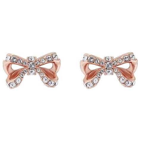 Ted Baker CALLAY Bow Stud Earrings This cute openwork design takes inspiration from the very first bow Ted created for his jewellery collection ten years ago. Adorned with Swarovski® crystals, the delicate CALLAYY stud earrings will add a touch of glamour to any outfit this season. Featuring silver tone plating and hypo-allergenic posts with secure butterfly backs. • For pierced ears only • Hypo-allergenic posts • Matching items available • 13 x 8 x 13 mm • Comes with a branded pouch and pillow Ted Baker Jewellery, Online Earrings, Rose Gold Earrings, Jewellery Collection, Silver Earrings Studs, Silver Studs, Ear Piercings, Ted Baker, Jewelry Pieces