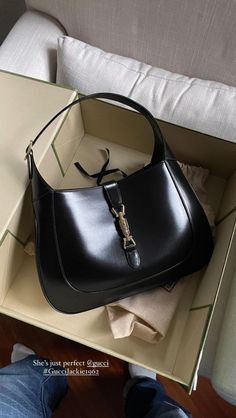 The reintroduction of the Jackie bag for Fall Winter 2020 presents a new take on a historical Gucci icon. Brought back to the forefront, the recognizable shape is presented in black leather and enhanced with an additional, detachable shoulder strap. Attached to the bag with a buckle closure, the second strap adds a contemporary feel to the archival style, providing new ways to wear—from top handle, shoulder to cross body. Pieces with versatile ways to wear and style embrace each person who is part of the House’s individual spirit. The Jackie 1961 Popular Designer Bags 2023, Designer Vintage Bags, Quiet Luxury Bags, Jackie Bag Outfit, Gucci Jackie Bag Outfit, Luxury Bags 2023, Luxury Bags Aesthetic, Old Money Bags, Vintage Dior Bag