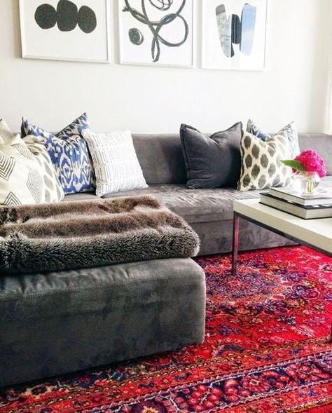 Decorating with Oriental & Persian Rugs -- Love this gorgeous living room with a gray faux suede sectional sofa, patterned gray and white throw pillows, a white marble topped coffee table and bright red embroidered and hand-knotted Persian area rug. Pink Rug Living Room, Persian Rug Living Room, Grey Couches, Cozy Sofa, Living Room Red, Trendy Living Rooms, White Throw Pillows, Gray Sofa, The Design Files