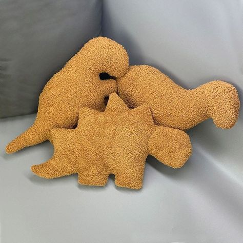 Features: Meet your new favorite and tastiest plushies, the Ultra Soft Dino-Nuggets Plush Pillows! The most perfect and cutest mix between widely beloved chicken nuggets and adorable dinosaurs. Choose your favorite dinosaur plushie to cuddle with today or collect them all! Crafted from high-quality and soft cotton materials, these pillows are both durable and comfortable, so you can cuddle and squish them for years to come. The perfect gift for your loved ones or for yourself as a little splurge Dino Nuggie Pillow, Dino Nuggets Pillow, Quirky Pillows, Nuggets Aesthetic, Dino Nugget Pillow, Weird Plushies, Giant Plushies, Funny Plushies, Unique House Decor