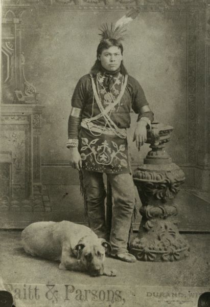 Full-length studio portrait in front of a painted backdrop of a Winnebago (Ho-Chunk) man wearing a headdress. A dog is laying on the floor near his feet. Native American Woman, Native American Images, Native American Pictures, Native American Photos, Indigenous Americans, Native American Tribes, American Woman, Native American History, Native American Culture