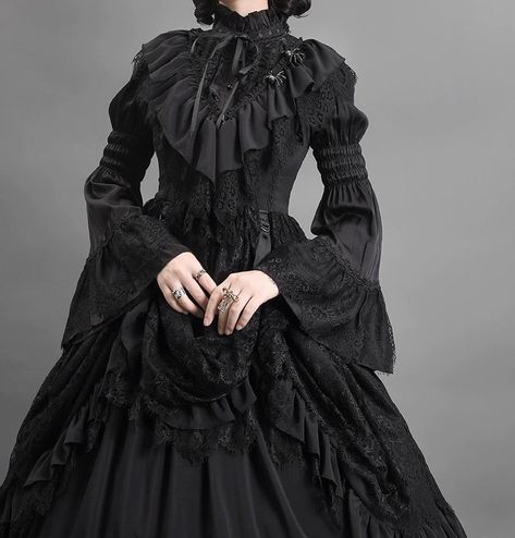 Step into a world of gothic elegance with our Black Gothic Lolita Ball Gown. This Victorian-inspired dress, adorned with layered tulle ruffles, is perfect for those seeking a dramatic and sophisticated look. Luxurious Black Fabric: Made from rich black fabric with intricate lace detailing, this gown exudes timeless gothic charm, ideal for formal events and themed occasions. Victorian-Inspired Design: The fitted bodice features exquisite lace patterns and a high collar, enhancing your silhouette with a touch of historical elegance. Layered Tulle Ruffle Skirt: The voluminous skirt, adorned with multiple layers of tulle ruffles, creates a stunning and dramatic silhouette, perfect for making a grand entrance. Perfect for gothic-themed parties, cosplay, or a unique wedding dress, this gown is a Gothic Vampire Dress Victorian, 18th Century Gothic Fashion, Victorian Gothic Gown, Diy Victorian Dress, Goth Quinceanera Dress, Victorian Tea Gown, Victorian Goth Clothes, Victorian Dress Design, Victorian Gothic Aesthetic Outfit