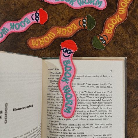 Add a touch of whimsy to your reading experience with our Bookworm Bookmark Patch. This adorable embroidered bookmark features a cheerful worm wearing a cowboy hat, perfect for book lovers and anyone who appreciates cute and quirky accessories. Key Features: Adorable Design: A charming and playful illustration of a bookworm. Versatile Use: Can be used as a bookmark or a sew-on patch. Measures Approx 5" x 2": The perfect size for most books. High-Quality Embroidery: Crafted with professional-grad Book Worm Bookmark, Book Worm Illustration, Felt Book Ornament, Bookmark Craft Diy, Stained Glass Bookmark, Hand Drawn Bookmarks, Embroidered Book Cover, Fabric Bookmarks Diy, Felt Bookmarks Diy