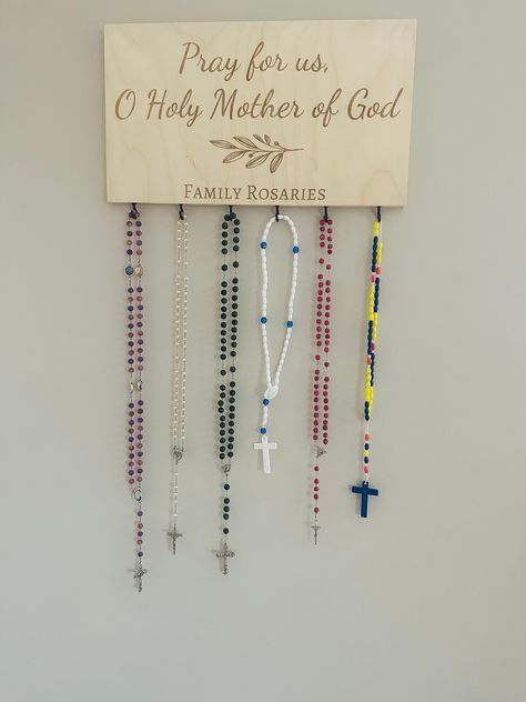 "A great addition to your prayer corner to display all of your family rosaries! You decide what gets engraved under the leaf image! This rosary holder is 15\" x 8\" x 0.5\" and is laser engraved on birch wood. You decide how many hooks you would like. The photo for this listing shows 6, but up to 8 can easily be added. Each rosary holder comes with a sawtooth hook installed for easy hanging. Each piece of wood has its own knots and color variations, which will make each rosary holder unique. *rosaries not included" Catholic Prayer Corner, Rosary Holder, Catholic Wedding Gifts, Catholic Christmas Gifts, Home Altar Catholic, Family Altar, Catholic Christmas, School Prayer, Prayer Corner