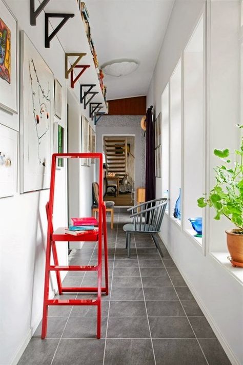 For a little extra storage, mount a shelf just below the ceiling along the length of a room. If your ceilings are tall enough, you'll barely notice it. This works especially well in a hallway, as spotted on Hus & Hem. Små Rum Lidt Plads, Small Hallway Ideas, Space Apartments, Small Entryways, Hallway Storage, Small Hallways, Small Space Solutions, Narrow Hallway, Small Space Living