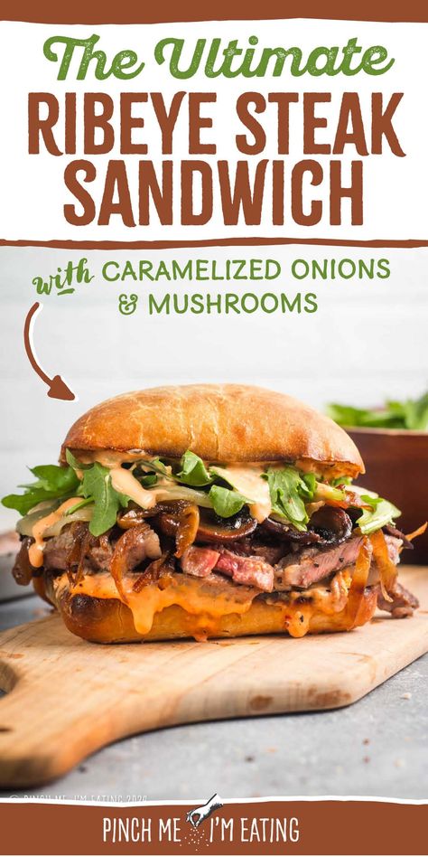 This grilled ribeye steak sandwich is loaded with roasted red pepper garlic aioli, arugula, provolone, caramelized onions, and mushrooms, all on a toasty ciabatta roll. You can even use thinly sliced leftover steak in this recipe! This sandwich is a great main course dish, and the sauce is out of this world! Steak Sandwich With Garlic Aioli, Ribeye Sandwich Recipe, Ribeye Steak Sandwich, Caramelized Onions And Mushrooms, Steak Sandwich Recipes, Grilled Ribeye Steak, Ciabatta Roll, Grilled Ribeye, Garlic Steak