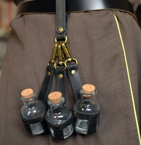 The set includes  three pieces of black leather potion holders.  Made of genuine leather and original fittings, which gives the product an authentic look. Each holder contains a glass bottles with a cork stopper (30 ml = 1 oz).  The spring hook makes it easy to attach and detach holders to belts and to any loops on clothes  Additionally, if necessary, you can order a loop for fastening The holder can be used for its intended purpose,  in role-playing games in the style of steampunk or Victorian Steampunk Belt, Crochet Belt, Fairy Accessories, Steampunk Wedding, Steampunk Accessories, Belt Accessories, Leather Pieces, Steampunk Fashion, Role Playing