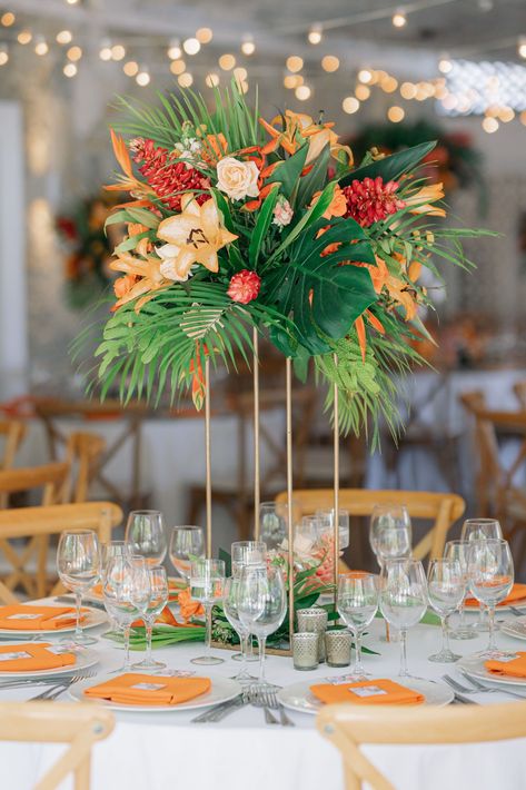 Tall tropical centrepieces with magnificent colors | Design by Kukua Wedding Team | Photo by Boyko | #kukuapuntacana #kukuaweddings #puntacanaweddings #weddingwire #luxurywedding #customwedding #wedding #weddings #weddingvenue #weddingcentrepiece #elegantcentrepiece #centrepieces #centrepiece #floralcentrepiece #tallcentrepiece #tablescapes #weddingreception #weddinginspiration #stylemepretty #tropicalwedding #tropicaltheme Tall Tropical Centerpiece, Elegant Tropical Wedding Decor, Tropical Wedding Theme Elegant, Aruba Style, Tropical Wedding Table Decor, Tropical Wedding Flowers Centerpieces, Tropical Wedding Ceremony, Orchid Centerpieces Wedding, Tropical Wedding Centerpieces