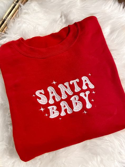 Get festive with our Santa Baby Crewneck Sweatshirt! The Unisex Sizing makes the sweatshirt run slightly larger than your average sweatshirt for women. Most men find their normal size to be more snug. If you want a slightly looser fit, size up one size. Please check out our size chart for measurements to ensure an accurate fit. PLEASE BE SURE TO INPUT YOUR CORRECT SIZE/COLOR + SHIPPING ADDRESS. We will not be responsible if it is incorrect! Refunds/Exchanges accepted, please read our Refund Poli Retro Christmas Sweatshirt, Christmas Crewneck Sweatshirt Cricut, Winter Sweatshirt Ideas, Cute Christmas Sweatshirts, Christmas Sweaters Aesthetic, Christmas Embroidery Sweatshirts, Embroidered Clothes Ideas, Vinyl Sweatshirt Ideas, Sweatshirt And Shirt Outfit