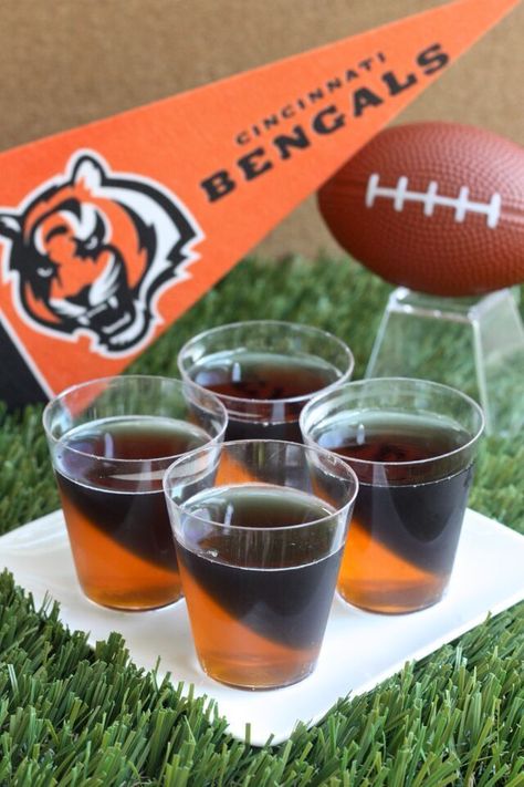 Cincinnati Bengals Jell-O Shots (3 oz. orange Jell-O 2 envelopes plain gelatin 2 cup vodka  3 1/2 Tbs grape Jell-O powder 3 1/2 Tbs lime Jell-O powder Black food coloring) Jell O Shots Recipe, Super Bowl Drinks, Jell O Shots, Jelly Shots, Black Food Coloring, Jello Shot, Football Snacks, Bengals Football, Themed Drinks