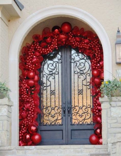 This impressive display requires quite a few ornaments (to put it mildly). If you don't have a few hundred matching red balls, a small take can look just as lovely. La Christmas, Christmas Door Decoration, Front Door Christmas Decorations, Elegant Christmas Decor, Christmas Front Doors, Fabulous Christmas, Have Inspiration, Xmas Ideas, Christmas Porch