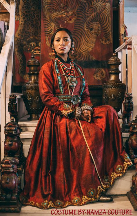 Wearing Ladakhi Culture means, you wearing a Ladakhi dress and Ladakhi jewellery. A "Sulma" in this picture is the red gown. The big coral earrings "Akor". The turquoise and coral necklace with a big amulet "Gau", which is considered the main piece of jewellery in Ladakhi wedding. Then below that is an ornament worn by the women of Sham valley, its called "Rhuptsey". The top part is tied to the neck and the bottom part around the waist so that the lotus-shaped jewellery is right in the centre. Traditional Ladakhi Dress, Dress That Ties Around Neck, Cultural Outfits Traditional Dresses, Ladakhi Dress, Cultural Clothing, Culture Clothing, Asian History, Period Outfit, Coral Earrings