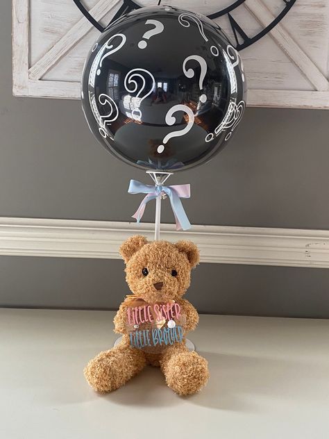 "This is a no mess ready to use gender reveal pop balloon. Surprise your family and friends at your reveal party.  Fun and mess free way to announce the gender. Personalize the acrylic disk the teddy bear is holding.  The teddy bear is holding an acrylic disk with the popping pin, for safety a foam ball has been added to the tip of the \"popping pin\".  The teddy bear is sitting on a round cardboard cake plate. The balloon stick holding base is glued to the round cardboard cake plate, so it is sturdy.  The ballon stick is placed through the back of the teddy bear's tie to hold him up and stuck down in the holding base. See pictures to illustrate what it all looks like. Very cute and sturdy.  The inside Question Mark balloon is made of latex and the outside bobo bubble balloon is made of a Balloon Pop Gender Reveal, Gender Reveal Balloon Pop, Creative Gender Reveals, Its A Girl Announcement, Teddy Bear Theme, Girl Gender Reveal, Gender Reveal Balloons, Gender Reveal Party Decorations, Balloon Pop