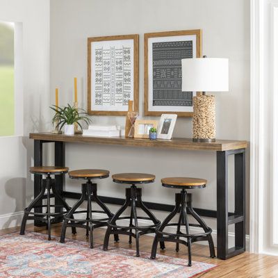 This counter height bar table and swivel stools are industrial vintage, rustic and the hand distressing enhances the overall aesthetic. The combination of materials, like the poplar veneer wood top, black hand distressed metal finish, and the extra thick metal tube base has an industrial appeal that will look great in any setting. Color: Brown | Williston Forge Wellman 4-Person Pub Table & Stool Set 36.0 H in black / whiteWood / Metal in Brown | Wayfair Rustic Pub Table, Counter Height Bar Table, Sofa Bar Table, Sofa Bar, Accent Table Decor, Counter Height Dining Table, Wood Sofa, Counter Height Dining Sets, Table Stool