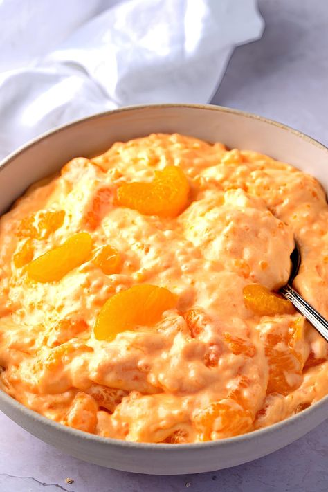 This Orange Creamsicle Salad is the stuff of dreams. Soft, creamy, sweet, and bursting with citrus- this easy dessert is ideal for your next get-together. Orange Creamsicle Salad, Creamsicle Salad, Desert Salad, Desert Salads, Fruit Salad With Pudding, Ambrosia Fruit Salad, Fluff Recipe, Fluff Desserts, Salad Easy