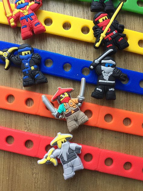 Lego Ninjago Carm Bracelets Party Favors | CatchMyParty.com #catchmyparty #partyideas #ninjago #legoninjago #birthdayparty Lego Ninja Party Favors, Lego Ninjago Party Favors, Ninjago Party Ideas, Ninjago Party Favors, Ninja Party Favors, Lego Ninjago Birthday Party, Birthday Party Game Ideas, Ninja Party Favor, Birthday Party Souvenirs