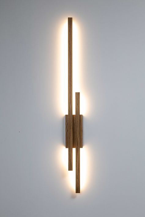 minimalist wooden linear wall lamp ambient light WAND TWO Modern Oak high quality handcrafted  WAND TWO lamp is a minimalist wall lamp with a simple and modern design. It consists of a long and short, horizontal wooden elements that attaches to a square bracket, which serves as the wall mount. The lamp emits soft, warm light directed downward, creating a gentle illumination effect on the wall below. The entire construction has a sleek, contemporary appearance and is made from natural oak wood, g Wand Lamp, Living Room Wall Lighting, Wall Bracket Light, Living Room Wall Lights, Ambient Lamp, Wooden Wall Lamp, Wood Wall Lamp, Wooden Wall Lights, Wood Wall Lamps