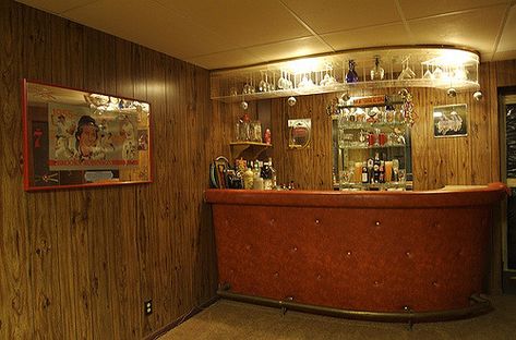 Yes, the bar is orange vinyl, the walls are wood paneling, and the carpet is shag. All are authentic.  I can only imagine the parties that have occurred in the thirty-five or so years since this basement was "finished". Well, I remember those that have occurred since I bought the house eight years ago, but I think you know what I mean... Basement Bar Wood Paneling, Retro Basement Bar, Bar Panelling, Vintage Basement Bar, Basement Bar Designs Small, Retro Basement Ideas, 70s Basement, Basement Speakeasy, 70s Bar