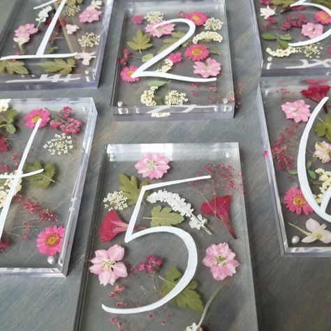 Our pressed flower table numbers! These are acrylic table numbers with pressed flowers between the layers and white writing Pressed Flower Table Numbers, Pressed Flower Table, Flower Numbers, Laser Wedding, Flower Table Numbers, Acrylic Table Numbers, Big Energy, Reception Tablescapes, Acrylic Table Number