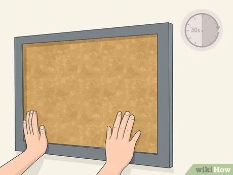 3 Easy Ways to Hang Cork Board - wikiHow Cubicle Wall, Cork Tiles, Cork Boards, Framed Cork Board, Cement Wall, Necklace Organizer, How To Hang, Hanging Jewelry, Picture Hangers