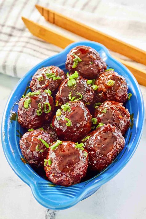 Looking for the perfect appetizer or game day snack? These Homemade BBQ Meatballs are a touchdown! Juicy homemade ground beef and pork meatballs baked in the oven to perfection and then smothered in tangy barbecue sauce on the stovetop or in a Crockpot. Impossible to resist, they're sure to be a crowd-pleaser at your next gathering. Get the easy recipe and find out how to make the best BBQ meatballs. Best Bbq Meatballs, Meatballs In Bbq Sauce, Homemade Bbq Meatballs, Easy Bbq Meatballs, Homemade Ground Beef, Bbq Meatball Recipe, Beef And Pork Meatballs, Meatballs Baked, Oven Baked Meatballs