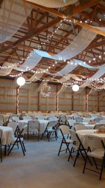 Machine Shed Wedding Reception Decor, Pole Building Wedding Reception, Shop Wedding Reception Decor, Indoor Wedding Receptions Simple, Wedding Shed Decorations, Metal Building Wedding Reception, Boho April Wedding, Simple Wedding Ceiling Decorations, Wedding Reception In Garage