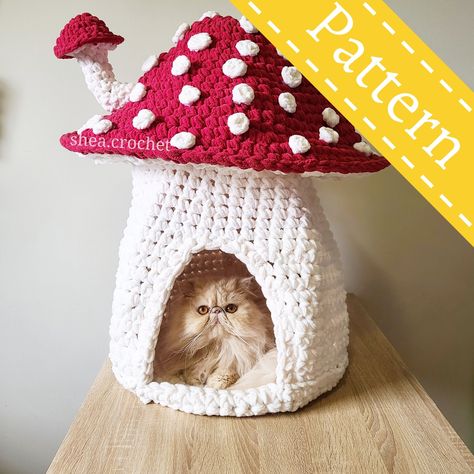 The purrfect cat bed for fall! Make your cat their own mushroom house with a little mushroom chimney sprouting out of the cap! This listing is for a 14 page PDF file crochet pattern. It contains step by step instructions, links to tutorials, and lots of photos to help you with your assembly. Finished size - approximately 21~ inches around the cap x 30~ inches tall. The doorway is 9 inches tall x 7 inches wide. Please note that this pattern is available in English only & it is a digital file (PDF pattern), not a physical item. Crochet Mushroom Cat House, Cat Bed House, Crochet Fairy Garden Free Pattern, Mushroom Cat Bed, Crochet Mushroom House, Crochet Fall Decorations Free Pattern, Crochet Cat Accessories, Crochet Housewarming, Crochet Home Decor Patterns Free