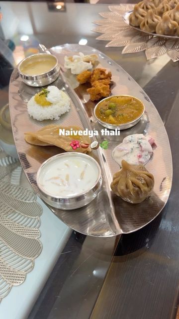 Srushti on Instagram: "Guess who’s waiting for Prasadam now? 😋 ❓Why do we present Naivedya to the idol? 🌺 Naivedya means food offerings made to god. 🌺 Naivedya offerings are made with deep reverence and devotion, symbolizing the act of surrendering to the divine. 🌺 The thali is usually placed on a circle drawn with water on the floor close to the idol’s feet. A small glass of water is placed with it on the right. 🌺 It is believed that when the offerings are presented to the deities, they p Silver Goddess, Pooja Items, Ganpati Decoration Design, Silver Pooja Items, Pooja Room Door Design, The Idol, Ganpati Decoration, Puja Room, Room Door Design